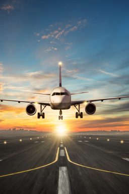 Passengers,Airplane,Landing,To,Airport,Runway,In,Beautiful,Sunset,Light,